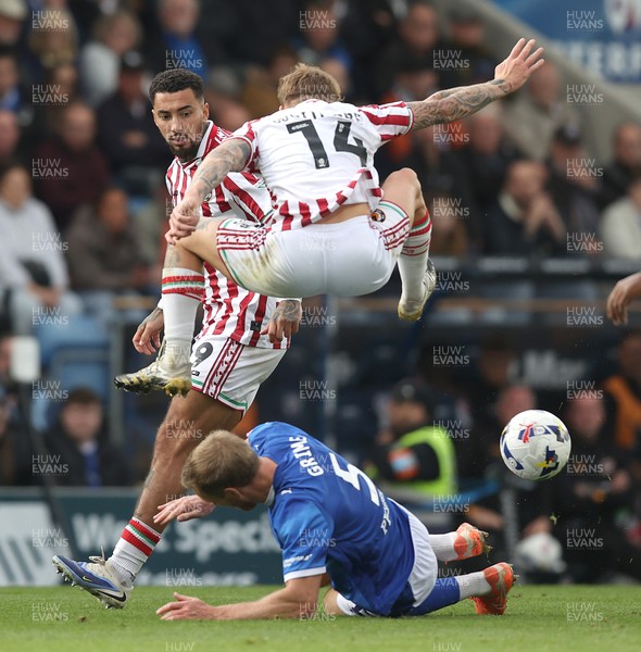 270925 - Chesterfield v Newport County - Sky Bet League 2 - Kai Whitmore of Newport leaps over Jamie Grimes of Chesterfield in the 2nd half