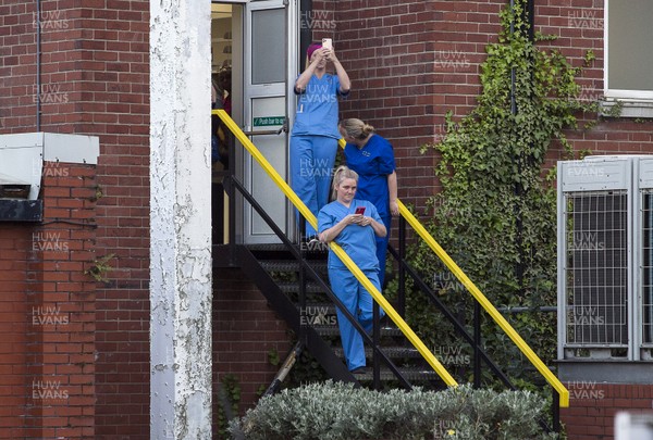 230420 - Picture shows hospital staff alongside the other emergency services and the public outside the Royal Gwent Hospital, Newport taking part in a clap for carers workers during the coronavirus (covid-19) lockdown