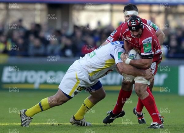 071213 - Clermont Auvergne v Scarlets - Heineken Cup - George Earle of Scarlets is tackled Daniel Kotze of Clermont 