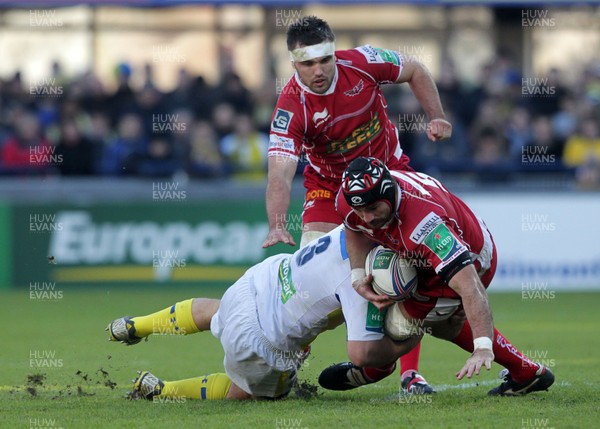 071213 - Clermont Auvergne v Scarlets - Heineken Cup - George Earle of Scarlets is tackled Daniel Kotze of Clermont 