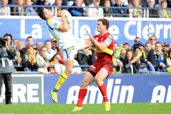 131012 - Clermont Auvergne v Scarlets - Heineken Cup -Lee Byrne of Clermont Auvergne takes high ball as George North of Scarlets closes in