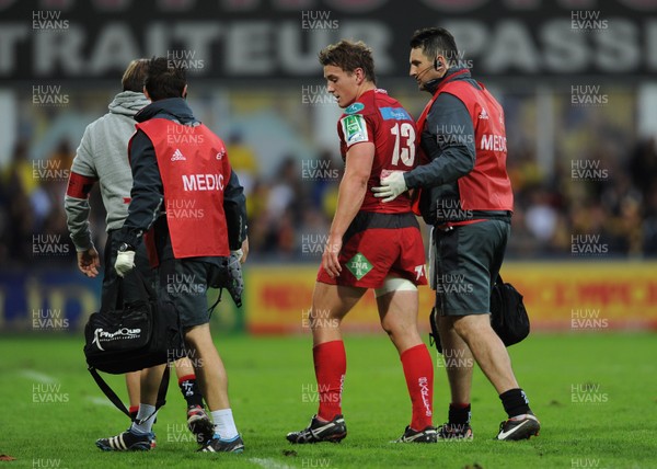 131012 - Clermont Auvergne v Scarlets - Heineken Cup -Jonathan Davies of Scarlets is helped from the field