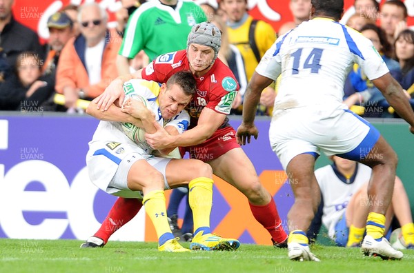 131012 - Clermont Auvergne v Scarlets - Heineken Cup -Lee Byrne of Clermont Auvergne is tackled by Jonathan Davies of Scarlets