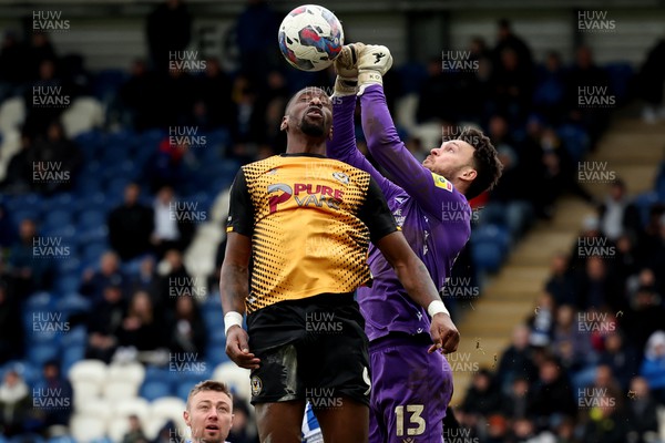 010423 - Colchester United v Newport County - Sky Bet League 2 - Kieran O'Hara of Colchester United punches the ball away from Omar Bogle of Newport County