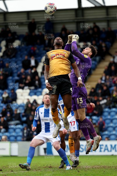 010423 - Colchester United v Newport County - Sky Bet League 2 - Kieran O'Hara of Colchester United punches the ball away from Omar Bogle of Newport County