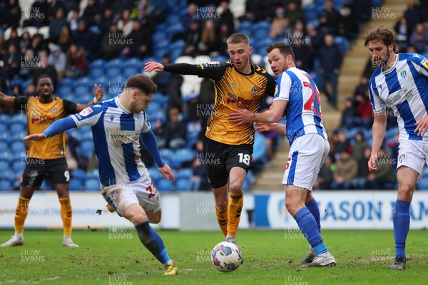 010423 - Colchester United v Newport County - Sky Bet League 2 - Matthew Baker of Newport County looses the ball in the area to Connor Wood of Colchester United