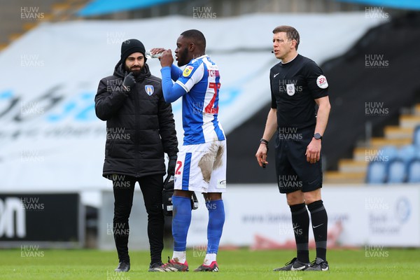 010423 - Colchester United v Newport County - Sky Bet League 2 - Second half is delayed as Junior Tchamadeu of Colchester United recovers after vomiting on the pitch