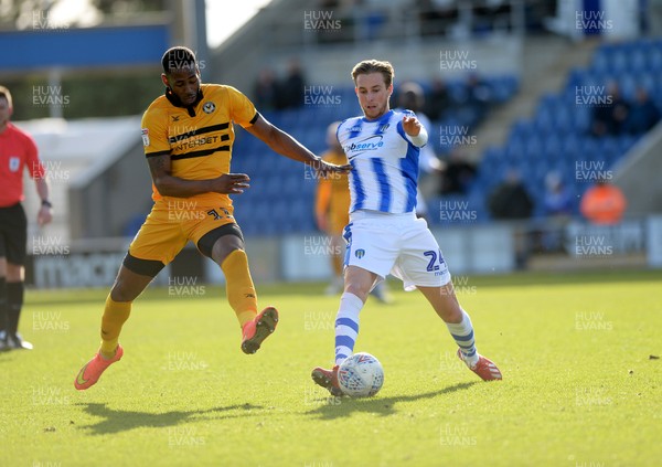 090319 - Colchester United v Newport County - Sky Bet League 2 -  Ben Stevenson of Colchester contests a ball with Newports Jamille Matt