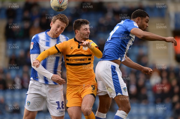 090319 - Colchester United v Newport County - Sky Bet League 2 -  Newports Padraig Amond goes for a header with Colchesters Tom Eastman