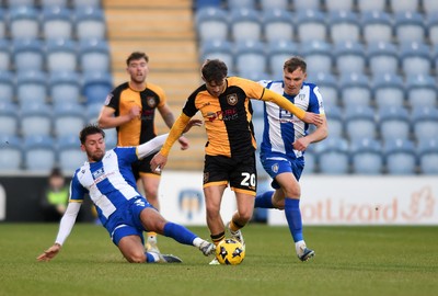 201225 - Colchester United v Newport County - Sky Bet League 2 - Ben Lloyd of Newport County battles with Ellis Iandolo of Colchester United
