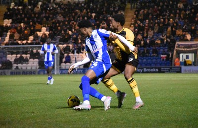 201225 - Colchester United v Newport County - Sky Bet League 2 -  Bobby Kamwa of Newport County battles Harvey Araujo of Colchester United