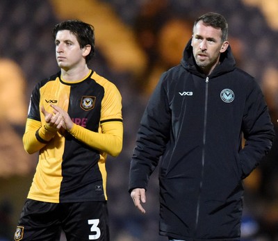 201225 - Colchester United v Newport County - Sky Bet League 2 - Anthony Driscoll-Glennon of Newport County and Newport County's manager David Hughes applauds fans after the final whistle 