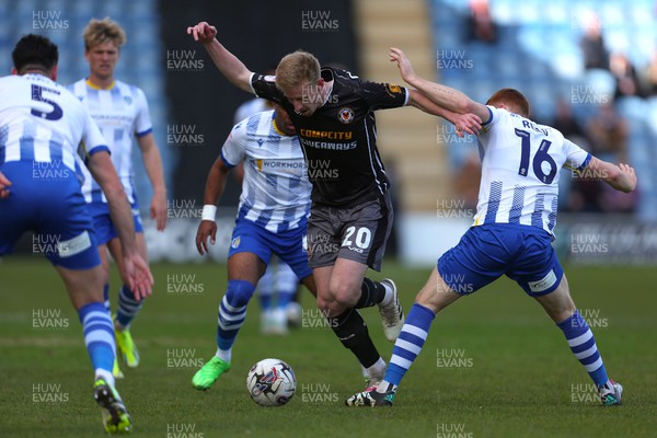 290324 - Colchester United v Newport County - Sky Bet League 2 - Harry Charsley of Newport County battling for the ball