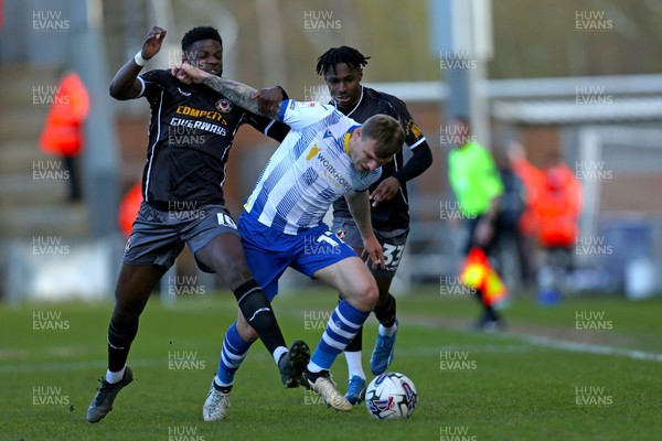 290324 - Colchester United v Newport County - Sky Bet League 2 - Offrande Zanzala of Newport County fighting for the ball