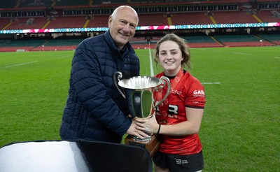 101225 - Coleg Gwent v Llandovery College Welsh Schools and Colleges Girls U18 Final - WRU President Terry Cobner presents the trophy to Coleg Gwent captain Lily Hawkins
