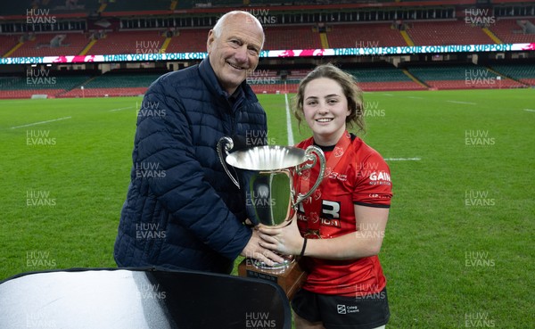 101225 - Coleg Gwent v Llandovery College Welsh Schools and Colleges Girls U18 Final - WRU President Terry Cobner presents the trophy to Coleg Gwent captain Lily Hawkins
