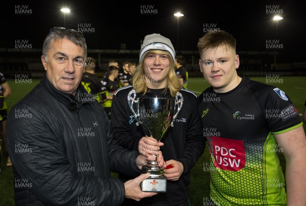 080119 -  Coleg Sir Gar v Coleg y Cymoedd, National Schools and Colleges League Final - Coleg y Cymoedd captains Ieuan Pring, right,  and Ioan Evans are presented with the trophy by Geraint John, Head of Rugby Performance for the WRU, after winning the National Schools and Colleges League Final