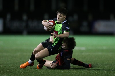 140120 - Coleg y Cymoedd v Coleg Gwent, WRU National Schools and Colleges League Final - Cameron Winnett of Coleg y Cymoedd is tackled by Carrick McDonough of Coleg Gwent