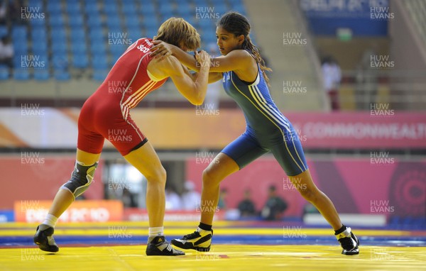 071010 - Commonwealth Games Delhi 2010 - Kiran Manu(blue) of Wales competes with Fiona Robertson of Scotland in the freestyle 48 kg women wrestling