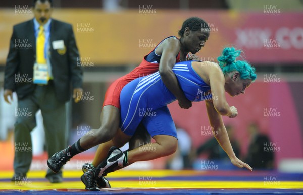 071010 - Commonwealth Games Delhi 2010 - Kate Rennie(blue) of Wales competes with Leah Wambui Ndungu of Kenya in the freestyle 63 kg women wrestling