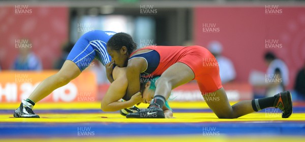 071010 - Commonwealth Games Delhi 2010 - Kate Rennie(blue) of Wales competes with Leah Wambui Ndungu of Kenya in the freestyle 63 kg women wrestling