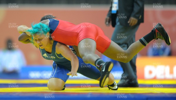 071010 - Commonwealth Games Delhi 2010 - Kate Rennie(blue) of Wales competes with Leah Wambui Ndungu of Kenya in the freestyle 63 kg women wrestling