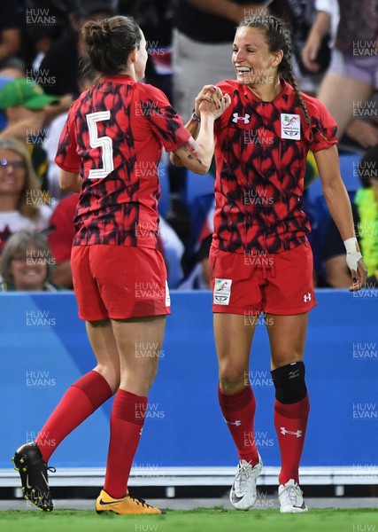 130418 - Rugby Sevens - Commonwealth Games - Laurie Harries (L) congratulates try scorer Jasmine Joyce