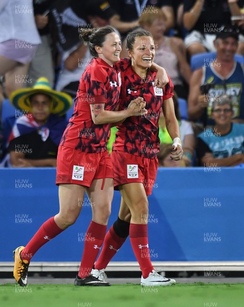 130418 - Rugby Sevens - Commonwealth Games - Laurie Harries (L) congratulates try scorer Jasmine Joyce