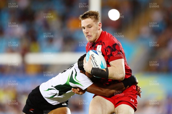 140418 - Rugby Sevens - Commonwealth Games - Thomas Williams of Wales is tackled