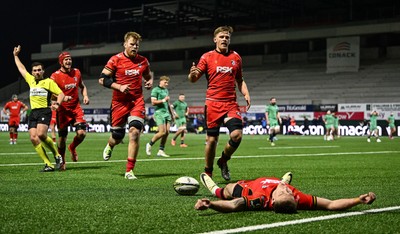050425 - Connacht v Cardiff Rugby - EPCR Challenge Cup Round of 16 - Cardiff Rugby players Josh McNally and Alex Mann, right, celebrate with team-mate Josh Adams as he lies on the pitch after scoring a second half try