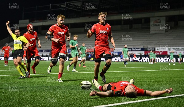 050425 - Connacht v Cardiff Rugby - EPCR Challenge Cup Round of 16 - Cardiff Rugby players Josh McNally and Alex Mann, right, celebrate with team-mate Josh Adams as he lies on the pitch after scoring a second half try