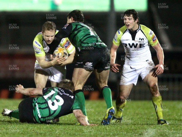 150213 Connacht v Ospreys - RaboDirect Pro12 - Ospreys' Thomas Issacs is tackled by Connacht's Eoin Griffin and Dani Poolman 