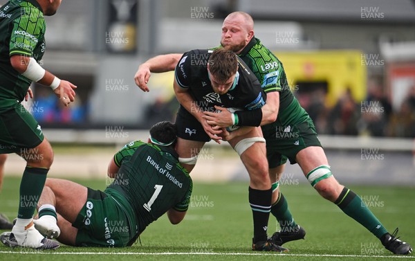 211023 - Connacht v Ospreys - United Rugby Championship - James Ratti of Ospreys is tackled by Denis Buckley, left, and Joe Joyce of Connacht