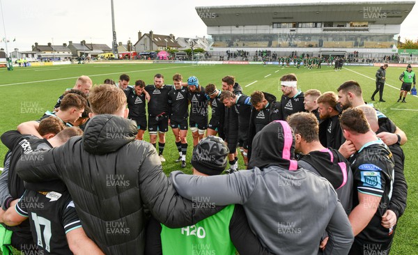 211023 - Connacht v Ospreys - United Rugby Championship - Ospreys players and coaching staff huddle after their side's defeat