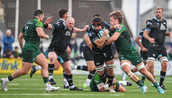 211023 - Connacht v Ospreys - United Rugby Championship - Morgan Morris of Ospreys is tackled by Cian Prendergast, right, and Jack Aungier of Connacht