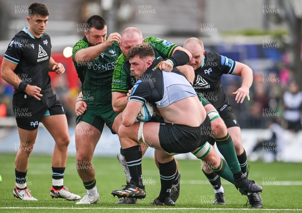 211023 - Connacht v Ospreys - United Rugby Championship - James Ratti of Ospreys is tackled by Joe Joyce, third from left, and Dylan Tierney-Martin of Connacht