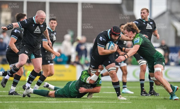 211023 - Connacht v Ospreys - United Rugby Championship - Morgan Morris of Ospreys is tackled by Cian Prendergast, right, and Jack Aungier of Connacht