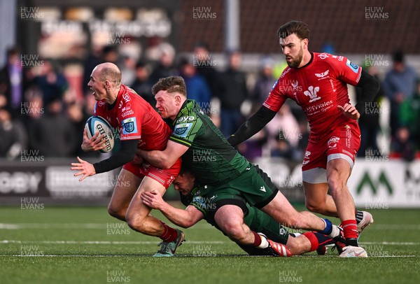 020324 - Connacht v Scarlets - United Rugby Championship - Ioan Nicholas of Scarlets is tackled by David Hawkshaw and Cathal Forde of Connacht