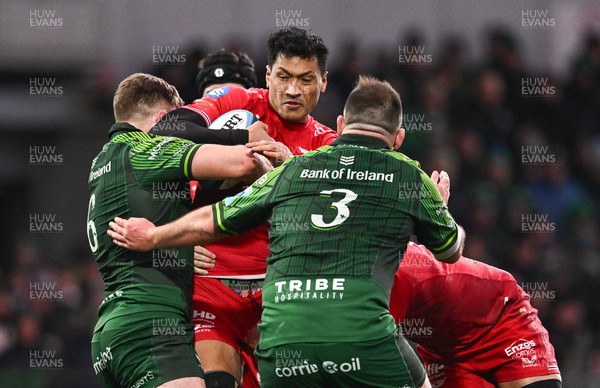 020324 - Connacht v Scarlets - United Rugby Championship - Sam Lousi of Scarlets is tackled by Cian Prendergast, left, and Jack Aungier of Connacht