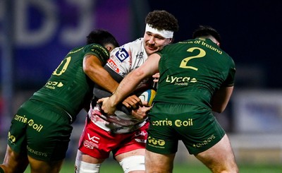 130326 - Connacht v Scarlets - United Rugby Championship - Fletcher Anderson of Scarlets is tackled by Josh Ioane, left, and Dylan Tierney-Martin of Connacht