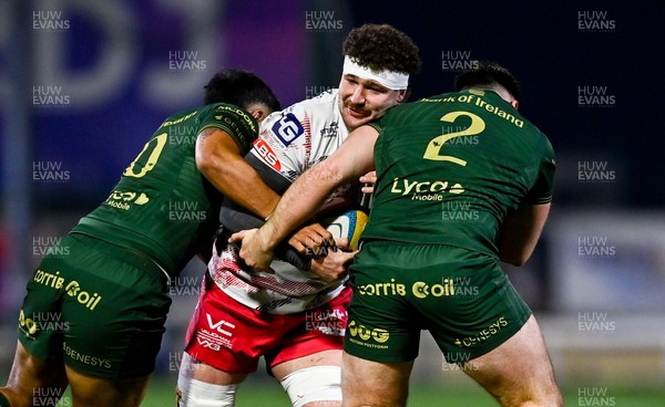130326 - Connacht v Scarlets - United Rugby Championship - Fletcher Anderson of Scarlets is tackled by Josh Ioane, left, and Dylan Tierney-Martin of Connacht