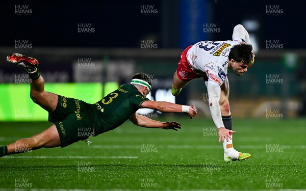 130326 - Connacht v Scarlets - United Rugby Championship - Joe Roberts of Scarlets evades the tackle of John Devine of Connacht
