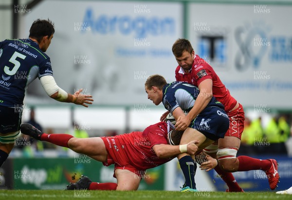 220918 - Connacht v Scarlets - Guinness PRO14 -  Kieran Marmion of Connacht is tackled by Phil Price, left and David Bulbring of Scarlets