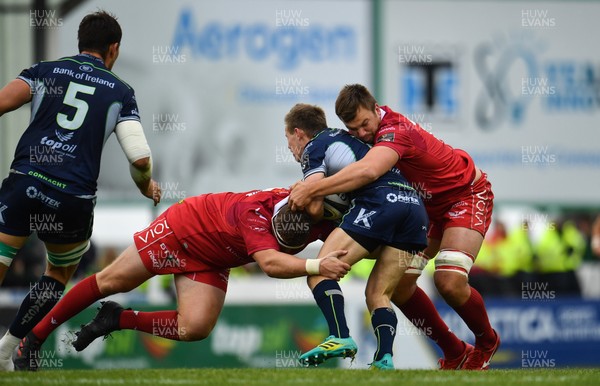 220918 - Connacht v Scarlets - Guinness PRO14 -  Kieran Marmion of Connacht is tackled by Phil Price, left and David Bulbring of Scarlets 