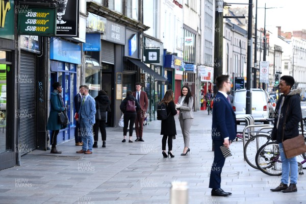 230320 - Coronavirus Outbreak - Company staff hold meeting with clients in the streets in Cardiff City centre during Monday morning