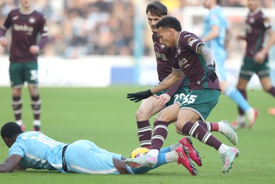 261225 - Coventry City v Swansea City - Sky Bet Championship - Ronald of Swansea and Liam Cullen of Swansea tackle Ephron Mason-Clark of Coventry