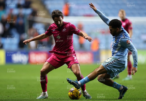 291223 - Coventry City v Swansea City - SkyBet Championship - Joe Allen of Swansea City is tackled by Jay Dasilva of Coventry 
