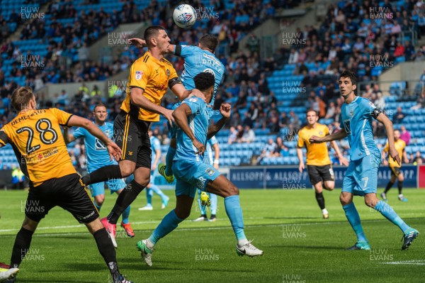 190817 - Coventry City v Newport County - Sky Bet League 2 - Newport County forward Joe Quigley (29) and Coventry City midfielder Michael Doyle (8) challenge for a header