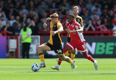 080825 - Crawley Town v Newport County, EFL Sky Bet League 2 - Kai Whitmore of Newport County holds off Reece Brown of Crawley Town