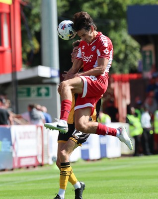 080825 - Crawley Town v Newport County, EFL Sky Bet League 2 - Joe Thomas of Newport County and Josh Flint of Crawley Town compete for the ball